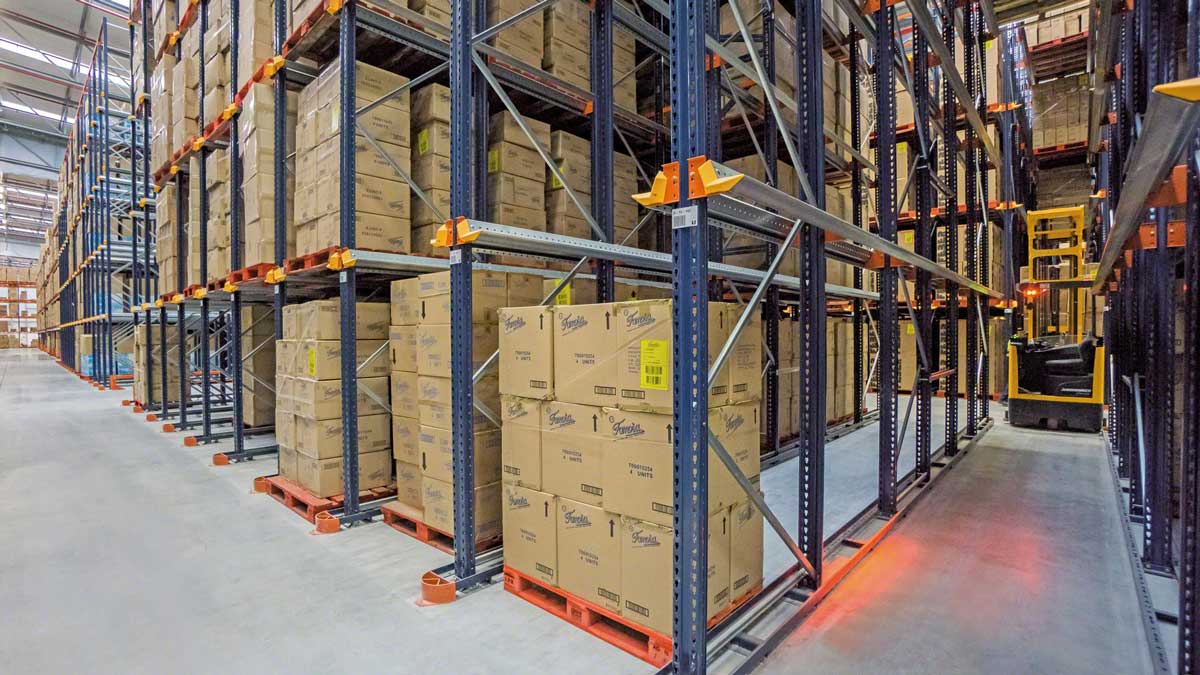 Gravity feed push back pallet racking system